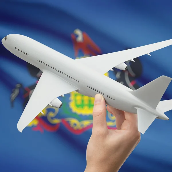 Airplane in hand with US state flag on background series - Pennsylvania — Stock Photo, Image