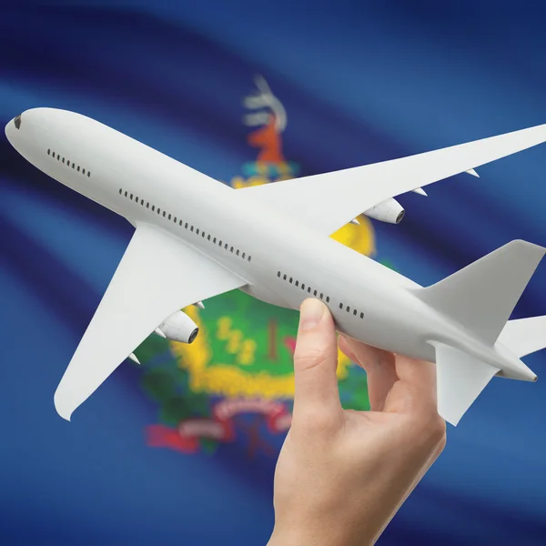 Airplane in hand with US state flag on background series - Vermont — 스톡 사진