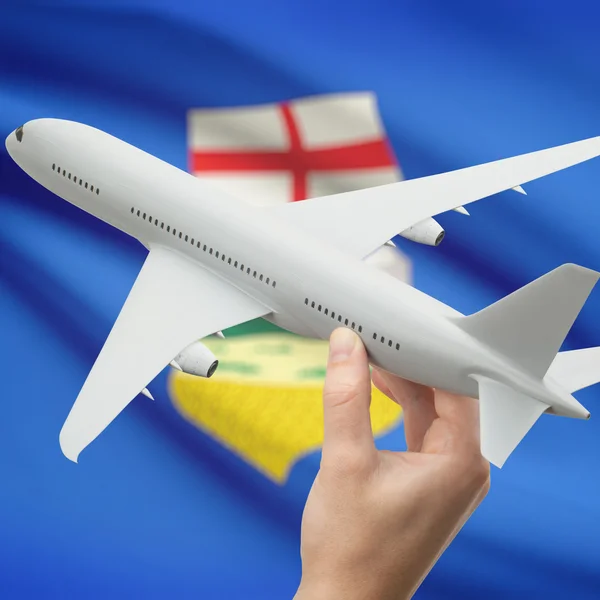 Airplane in hand with Canadian province flag on background series - Alberta — Stockfoto