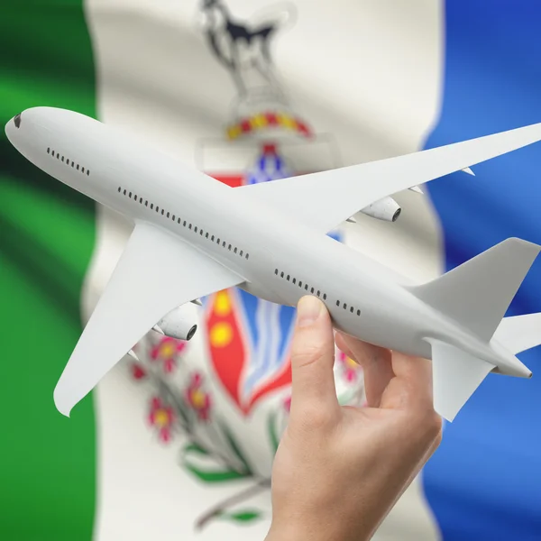 Airplane in hand with Canadian province flag on background series - Yukon — Stock Photo, Image