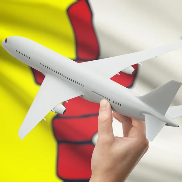 Airplane in hand with Canadian province flag on background series - Nunavut — Zdjęcie stockowe