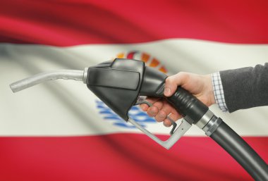 Yakıt pompa meme el ile arka plan - Fransız Polinezyası Ulusal bayrağı