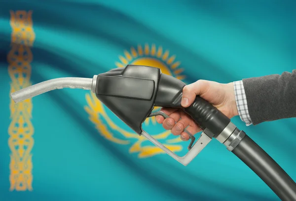 Fuel pump nozzle in hand with national flag on background - Kazakhstan — Stock Photo, Image