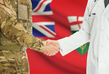 Military man in uniform and doctor shaking hands with Canadian provincies and territories flags on background - Ontario