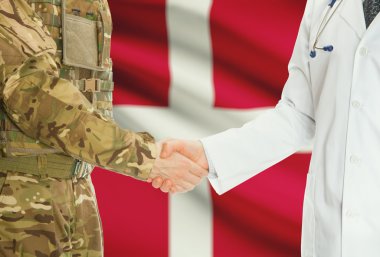 Military man in uniform and doctor shaking hands with national flag on background - Denmark