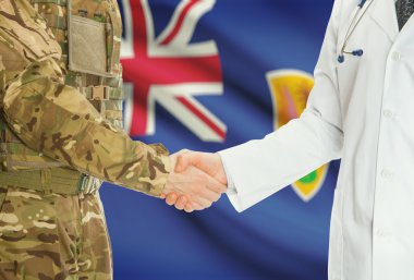 Military man in uniform and doctor shaking hands with national flag on background - Turks and Caicos Islands