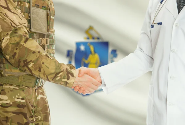 Military man in uniform and doctor shaking hands with US states flags on background - Massachusetts — Stok fotoğraf