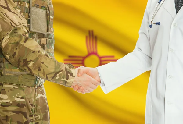 Military man in uniform and doctor shaking hands with US states flags on background - New Mexico — Foto de Stock