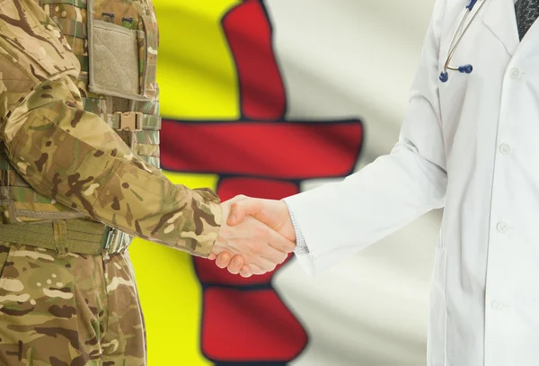 Military man in uniform and doctor shaking hands with Canadian provincies and territories flags on background - Nunavut — Stok fotoğraf