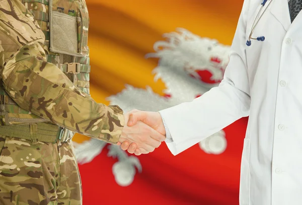 Military man in uniform and doctor shaking hands with national flag on background - Bhutan — 图库照片