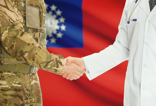 Military man in uniform and doctor shaking hands with national flag on background - Burma — Stok fotoğraf