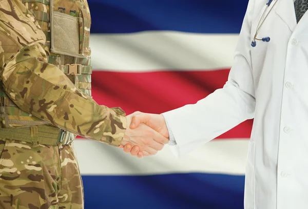 Military man in uniform and doctor shaking hands with national flag on background - Costa Rica — 图库照片