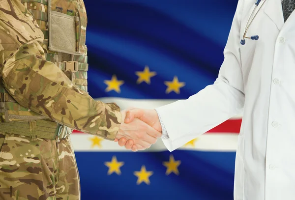 Military man in uniform and doctor shaking hands with national flag on background - Cape Verde — Stockfoto
