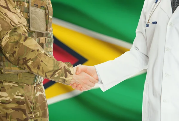 Military man in uniform and doctor shaking hands with national flag on background - Guyana — Stock Photo, Image