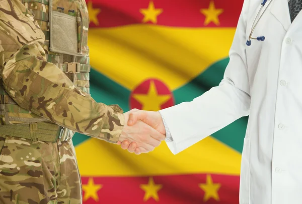 Military man in uniform and doctor shaking hands with national flag on background - Grenada — 图库照片