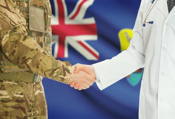 Military man in uniform and doctor shaking hands with national flag on background - Saint Helena — Stock fotografie