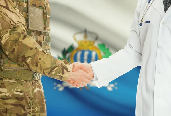 Military man in uniform and doctor shaking hands with national flag on background - San Marino — Stok fotoğraf