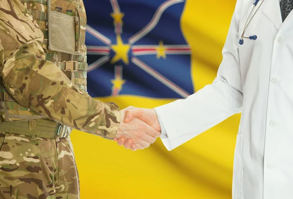 Military man in uniform and doctor shaking hands with national flag on background - Niue — 图库照片
