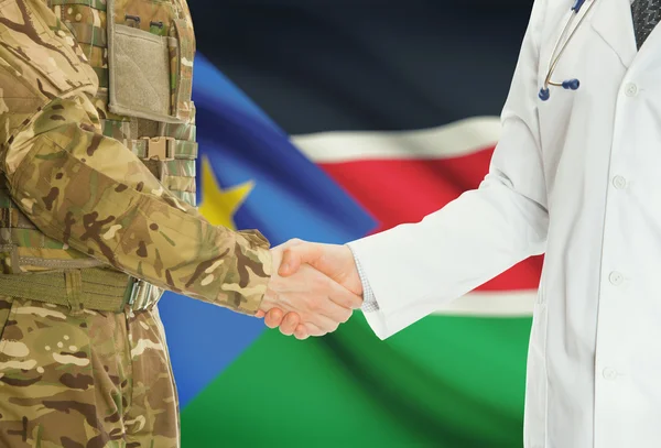 Military man in uniform and doctor shaking hands with national flag on background - South Sudan