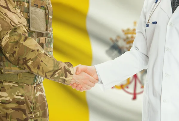 Military man in uniform and doctor shaking hands with national flag on background - Vatican City State — 图库照片