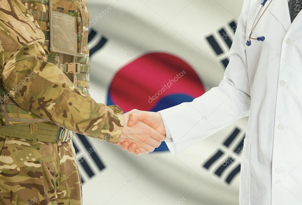 Military man in uniform and doctor shaking hands with national flag on background - South Korea