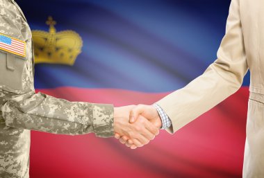 USA military man in uniform and civil man in suit shaking hands with national flag on background - Liechtenstein