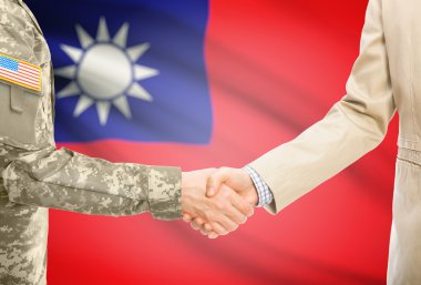 USA military man in uniform and civil man in suit shaking hands with national flag on background - Taiwan