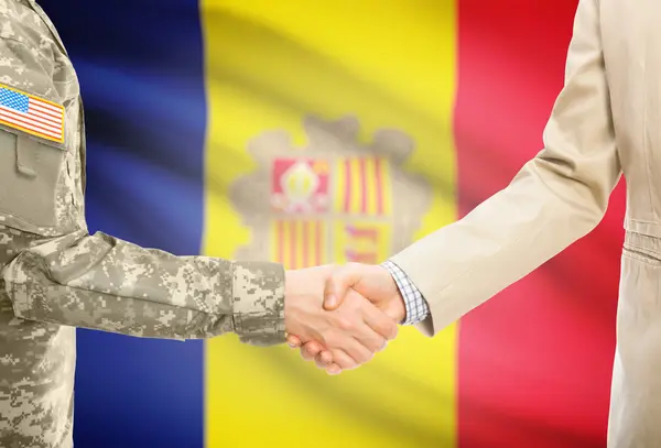 USA military man in uniform and civil man in suit shaking hands with national flag on background - Andorra — Foto de Stock