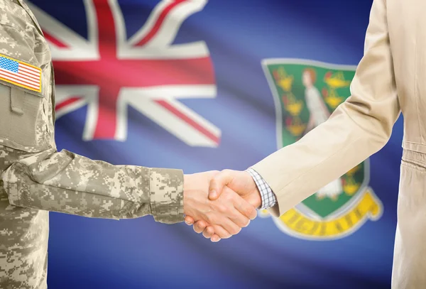 USA military man in uniform and civil man in suit shaking hands with national flag on background - British Virgin Islands — Stockfoto