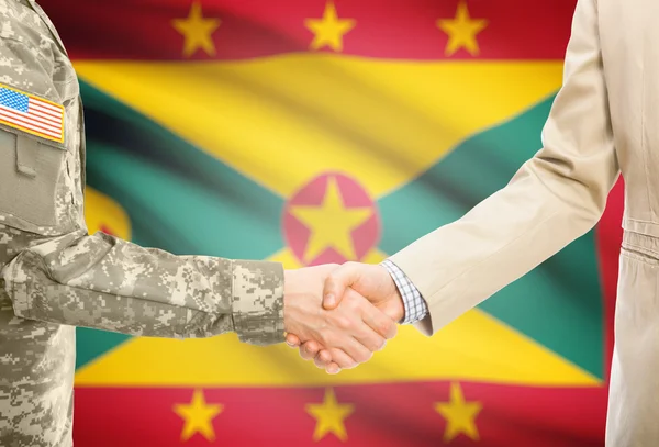 USA military man in uniform and civil man in suit shaking hands with national flag on background - Grenada — Stock fotografie