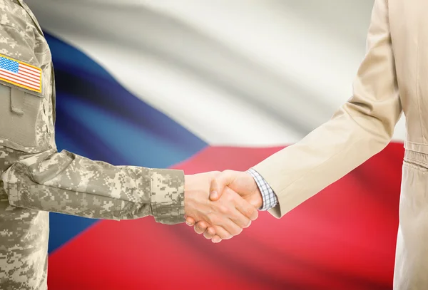 USA military man in uniform and civil man in suit shaking hands with national flag on background - Czech Republic —  Fotos de Stock