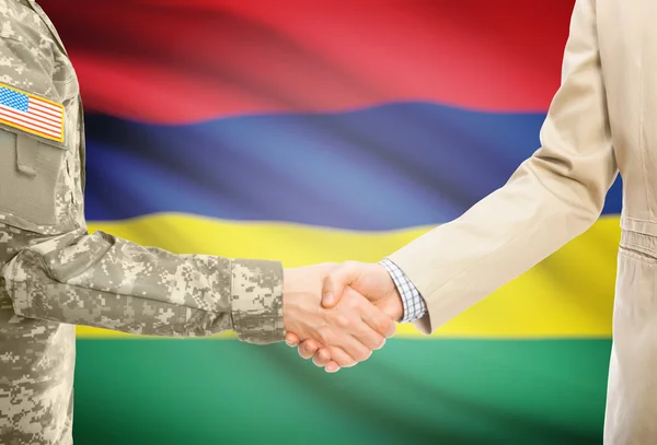 USA military man in uniform and civil man in suit shaking hands with national flag on background - Mauritius — Foto de Stock