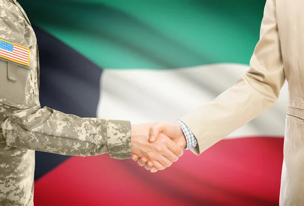 USA military man in uniform and civil man in suit shaking hands with national flag on background - Kuwait — 스톡 사진