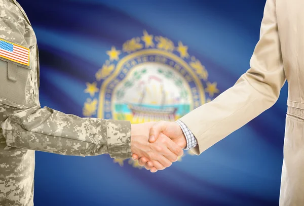 USA military man in uniform and civil man in suit shaking hands with USA state flag on background - New Hampshire — 스톡 사진