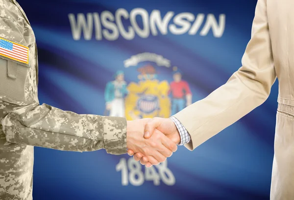 USA military man in uniform and civil man in suit shaking hands with USA state flag on background - Wisconsin — Zdjęcie stockowe