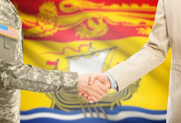 USA military man in uniform and civil man in suit shaking hands with Canadian province flag on background - New Brunswick — 图库照片