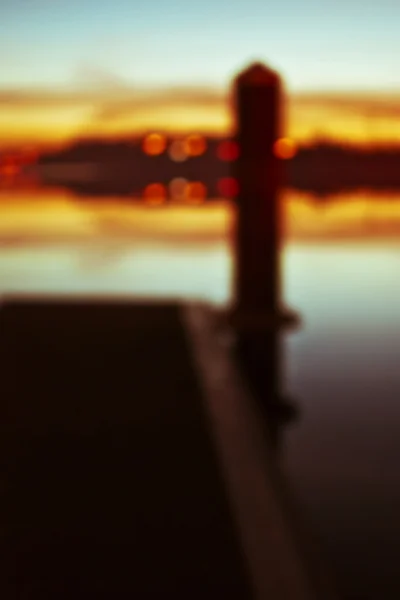Oskärpa solnedgången från piren. — Stockfoto