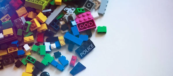 A bunch of multicolored Lego blocks on a light background.