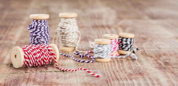 Spool of thread  on wooden table 