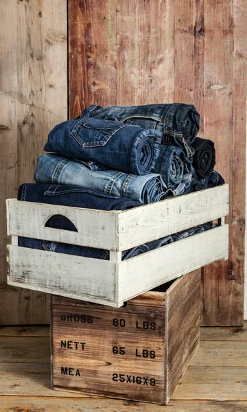 Jeans over wooden background — Stock Photo, Image