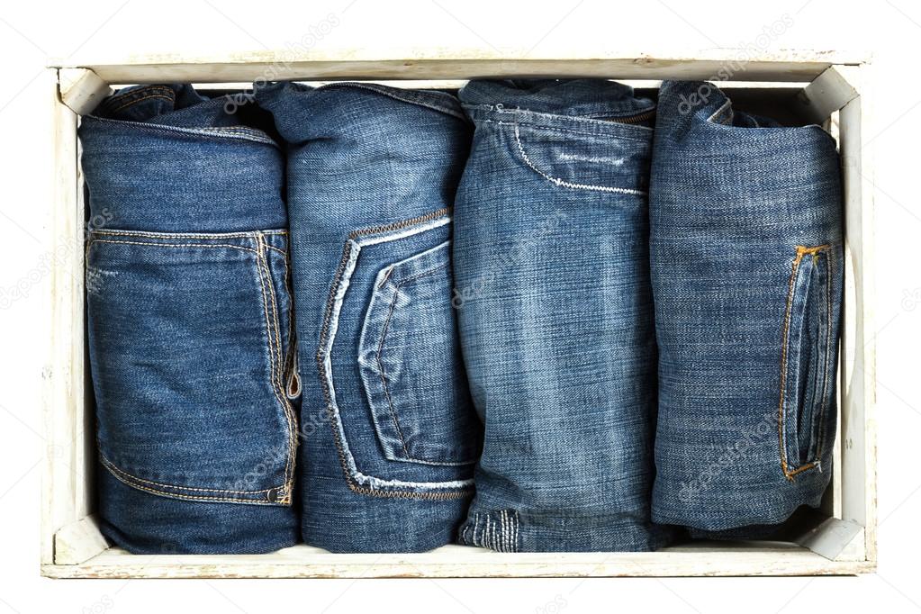 Blue Jeans over wooden background