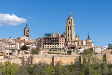 A far away view of Segovia's downtown from the front plaza of the Alcazar castle, providing a sweeping panorama of the historic Segovian city skyline and the distant downtown
