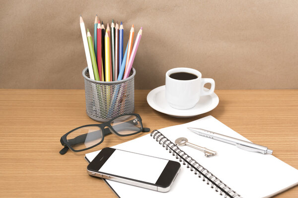 office desk : coffee and phone with key,eyeglasses,notepad,penci