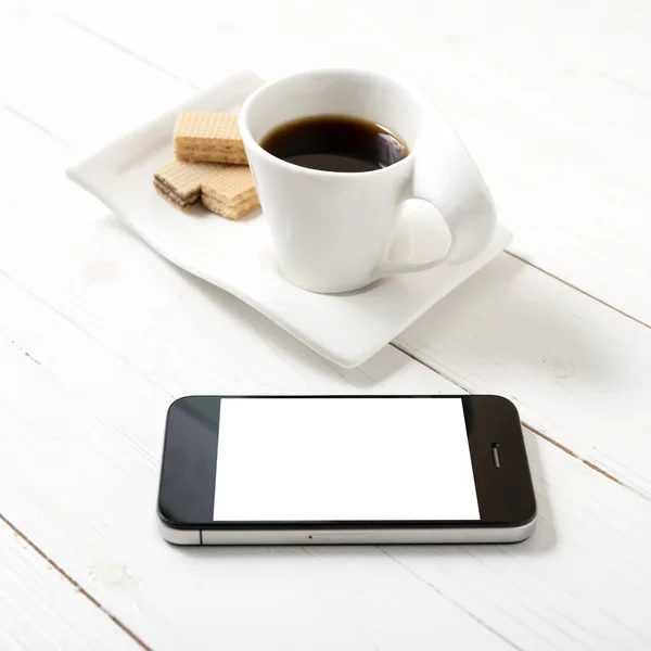 coffee cup with wafer and phone