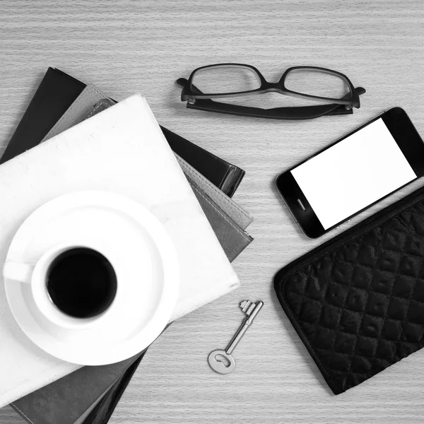 coffee and phone with stack of book,key,eyeglasses and wallet bl