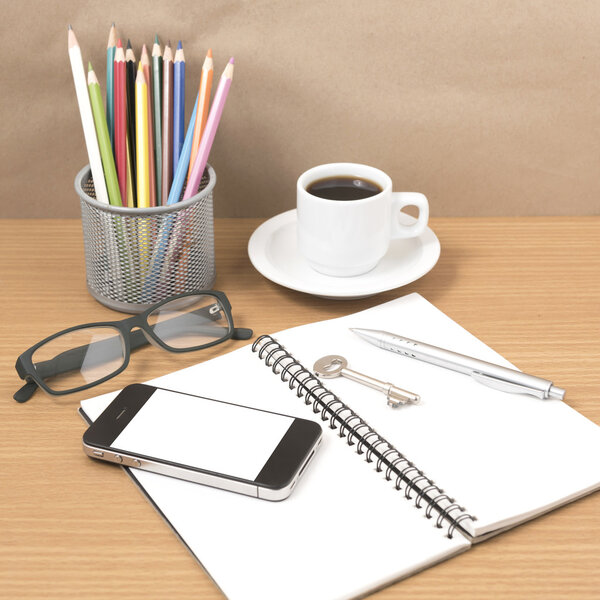 office desk : coffee and phone with key,eyeglasses,notepad,penci