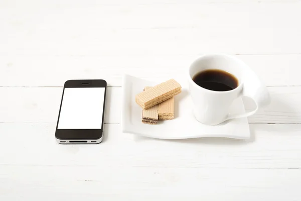 coffee cup with wafer and phone