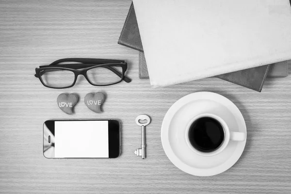 office desk : coffee and phone with key,eyeglasses,stack of book