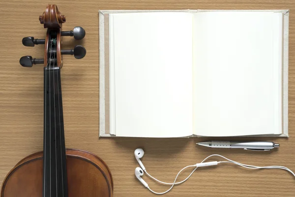 top view of violin notebook and earphone