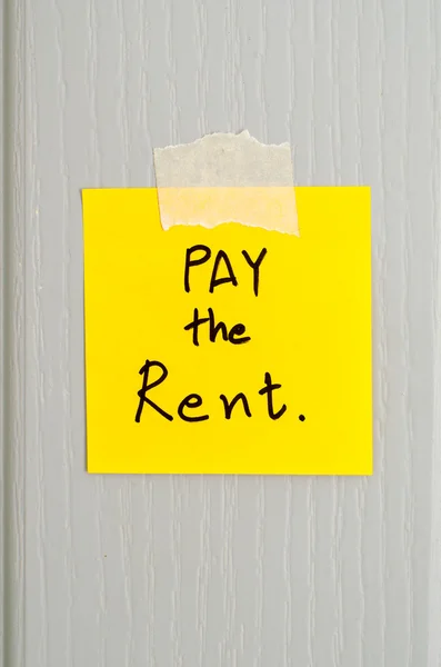 sticky note write a message pay the rent
